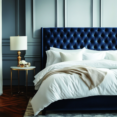 Velvet bed frame with tufted headboard and navy blue upholstery