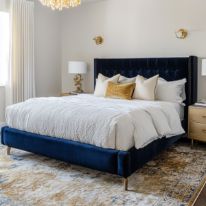 Navy velvet bed frame in a sophisticated bedroom makeover with gold accents