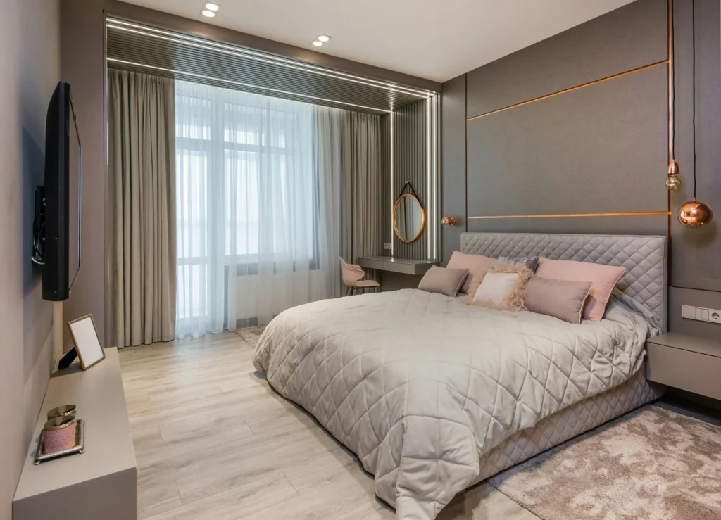 Spacious modern bedroom showing floor clearance around a large king bed with nightstands