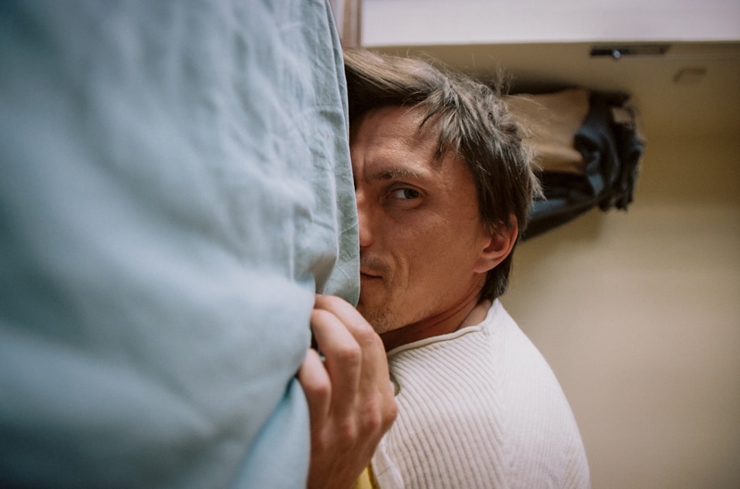 This photo models care and maintain bedroom carpets tips by showing a hand blotting a fresh spill with a white cloth to prevent permanent stains.