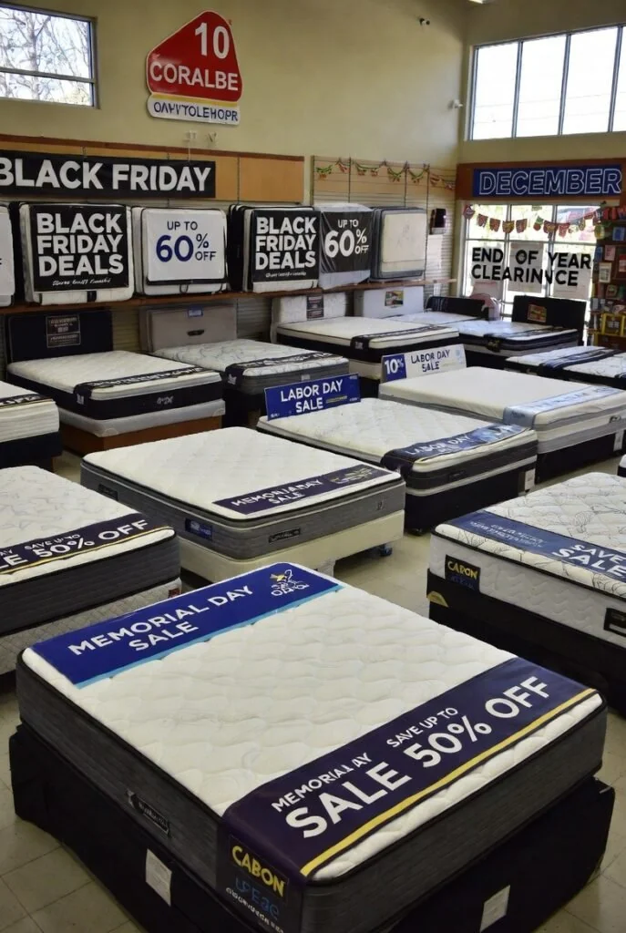 Labor Day mattress sale with multiple models and discount signage - mattress sales