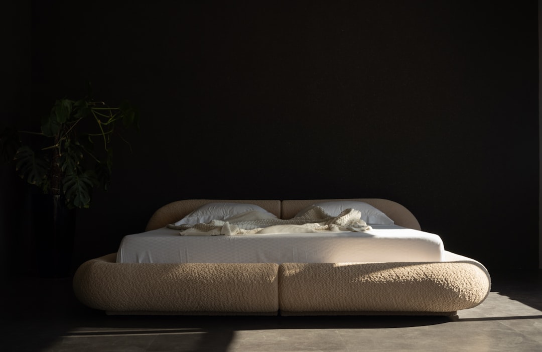 A mirror positioned opposite a window brightens a bedroom and reinforces the illusion of space.