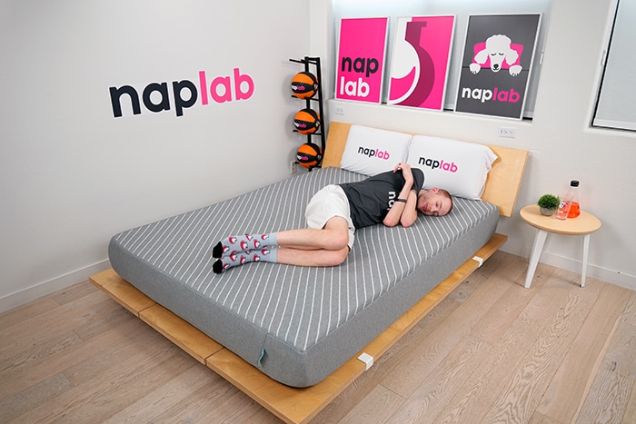 Side sleeper enjoying deep pressure relief and spinal alignment on Bud featuring budget comfort mattresses under