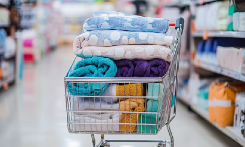 Shopping cart filled with bedding essentials like comforter sets, pillowcases, and towels, highlighting deals available during the Best Time to Buy Bedding.