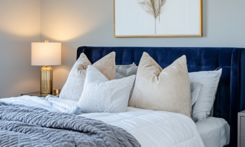 Velvet 1 Navy velvet bed frames in small bedrooms with white bedding and wall sconces
